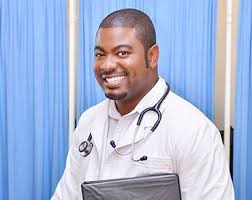 Sam Musariri in a white coat and stethoscope, holding a folder.